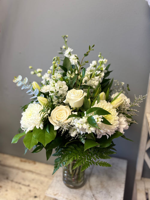 Ever After is a timeless, all-white floral arrangement of lilies, chrysanthemum and roses designed to bring peace, express sympathy and celebrate eternal life. Delivery to Hamilton and Burlington Funeral Homes. 