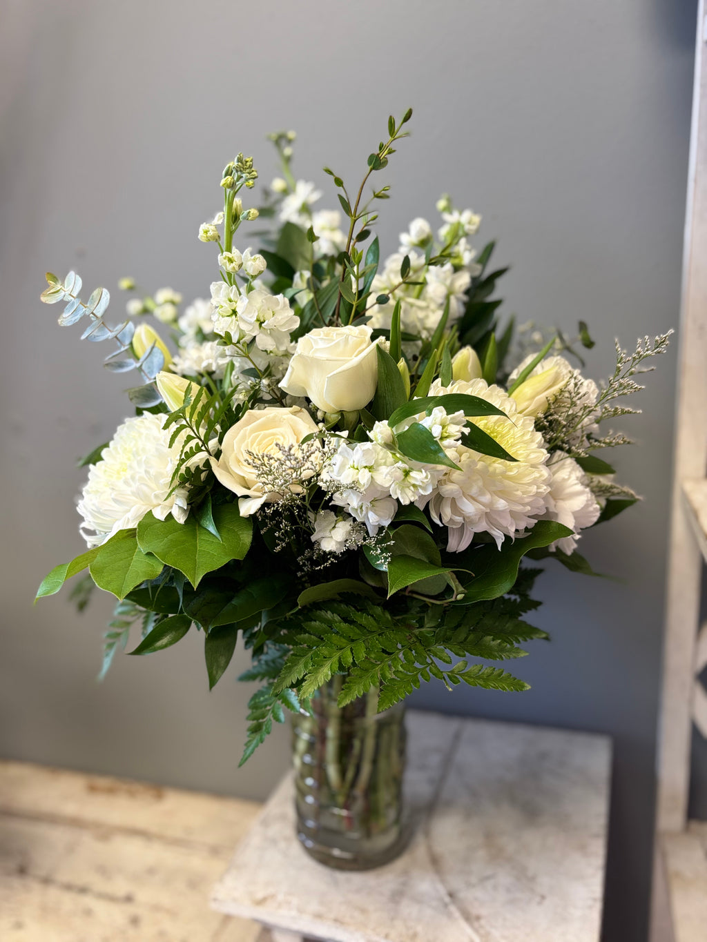 Ever After is a timeless, all-white floral arrangement of lilies, chrysanthemum and roses designed to bring peace, express sympathy and celebrate eternal life. Delivery to Hamilton and Burlington Funeral Homes. 