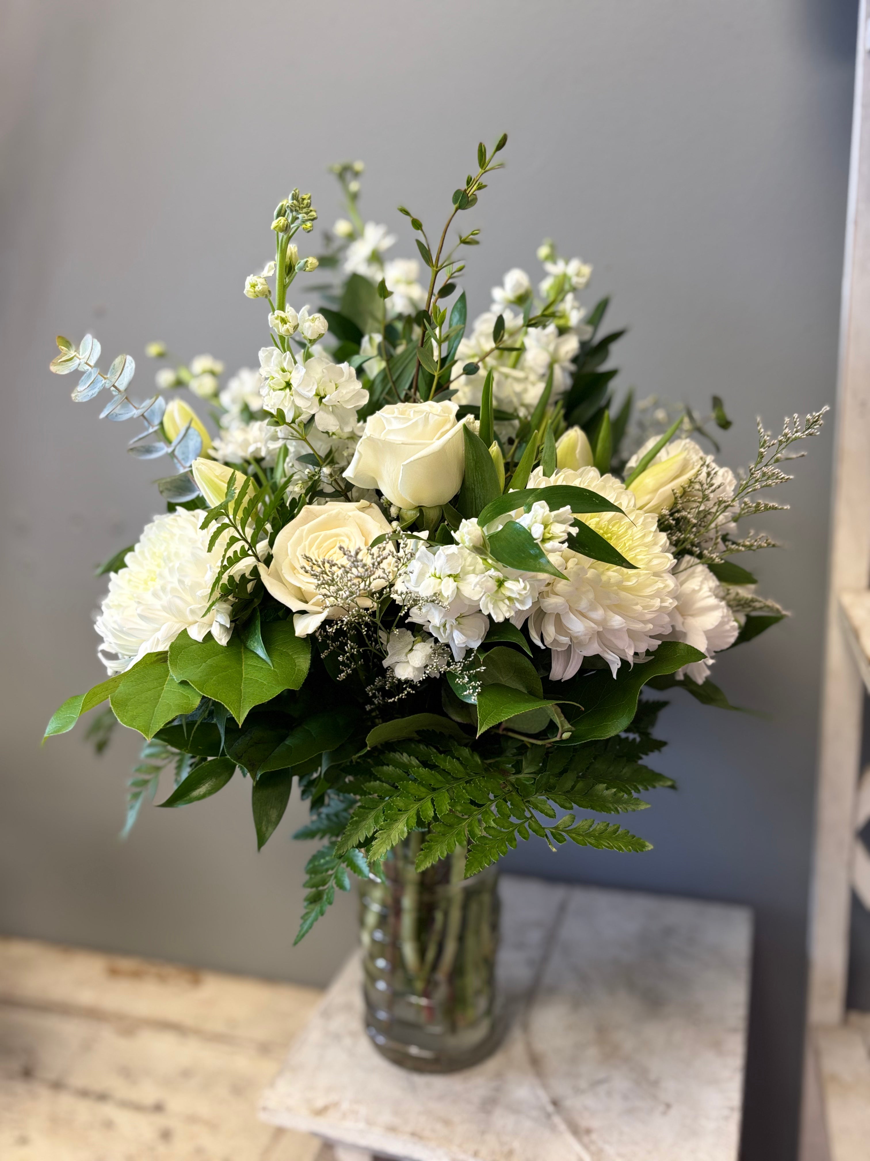 Ever After is a timeless, all-white floral arrangement of lilies, chrysanthemum and roses designed to bring peace, express sympathy and celebrate eternal life. Delivery to Hamilton and Burlington Funeral Homes. 