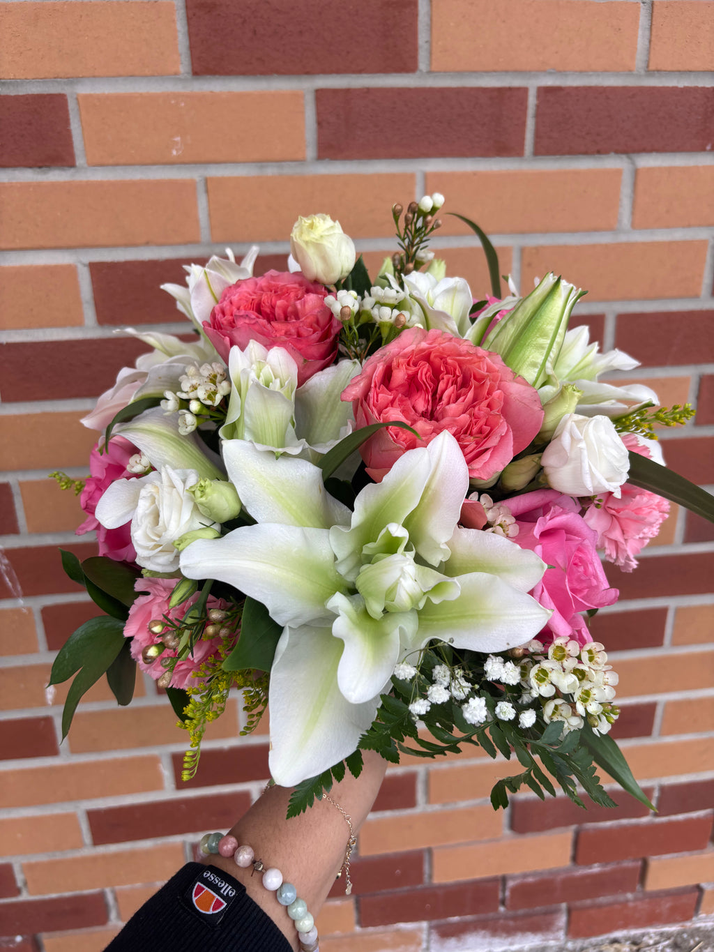 white lillies, pink garden roses and carnations