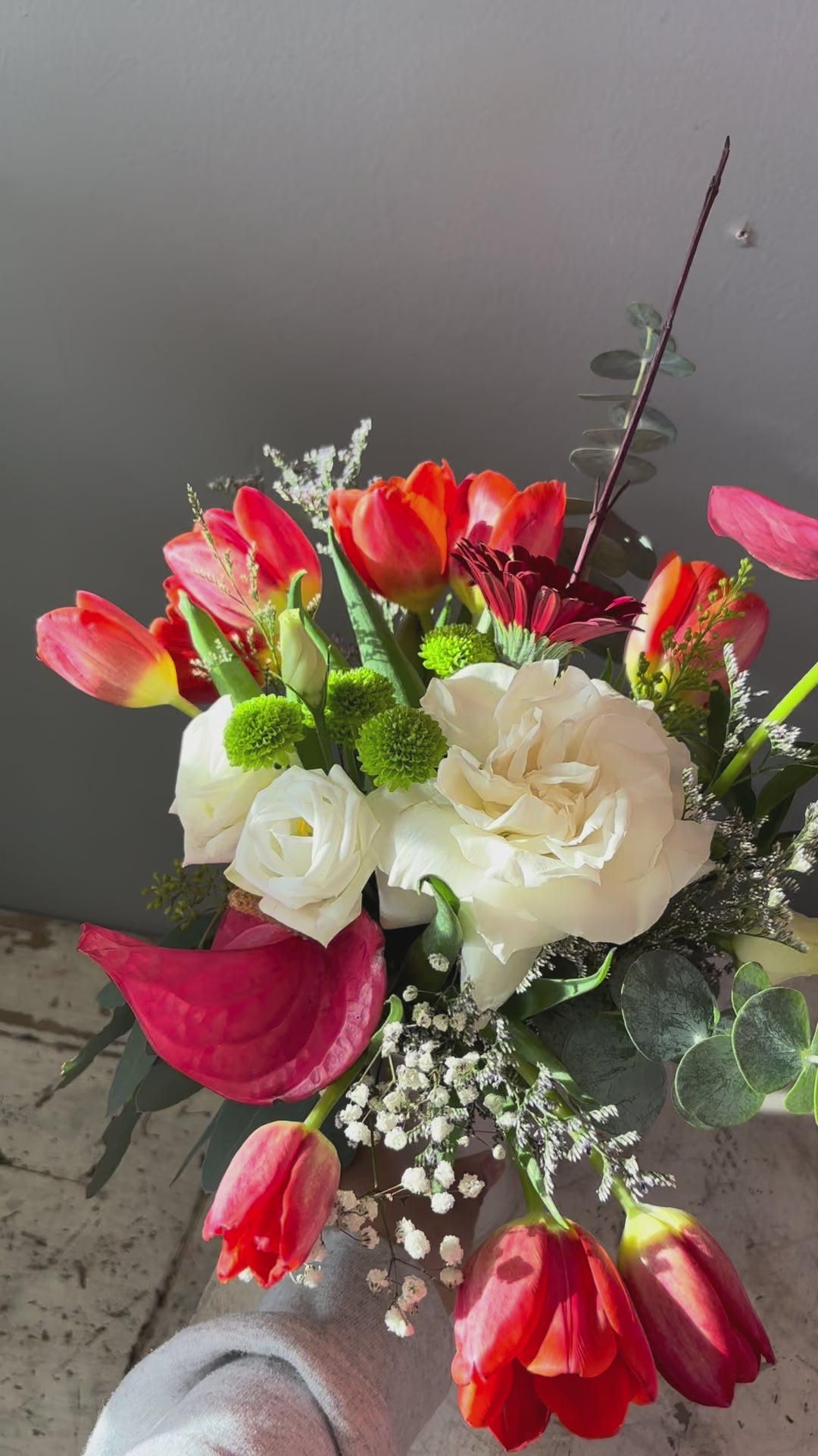 Sunward is a striking arrangement designed to reach upward and tell a story of warmth, resilience, and choosing hope.

Sculptural anthurium and vivid red tulips reach toward the light alongside a white rose, soft white lisianthus, deep red gerbera, and grounded with seasonal greens.

Designed in a modern white vase, this piece feels expressive and intentional. Simultaneously bold and tender, it’s a reminder not to let the fire burn out, even in seasons of change.

Perfect for moments of encouragement.