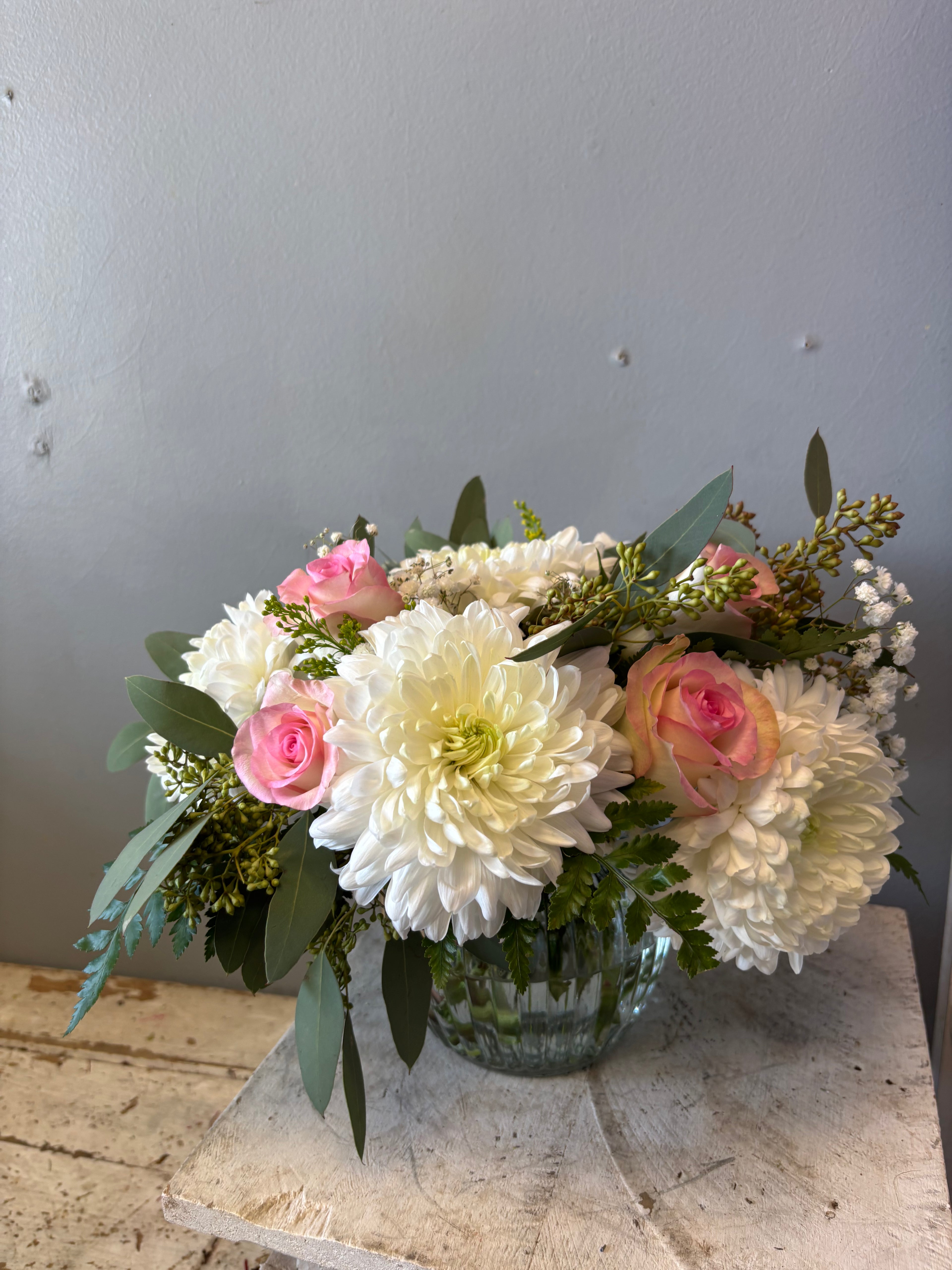 Romantic, lush, and layered with soft textures, Safe Haven is designed to feel abundant and elegant without being overwhelming. Featuring seasonal blooms such as roses, lilies, and fresh greenery when available, this arrangement brings a gentle richness to any room.
A lovely choice for celebrations, anniversaries, and heartfelt moments.
