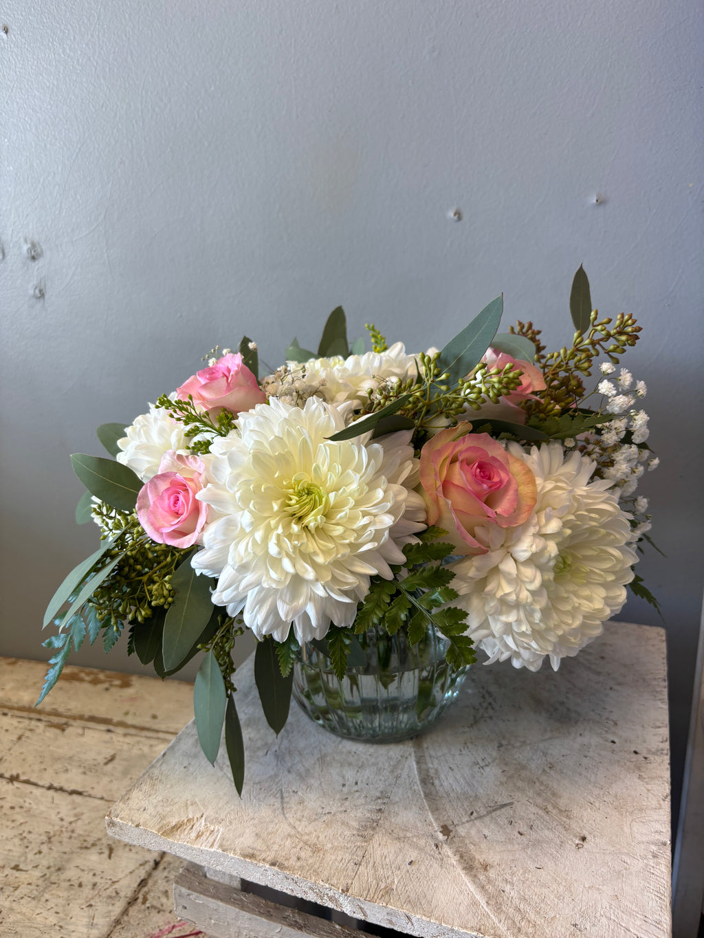 Safe Haven is a gently flowing arrangement designed in a calm, romantic palette of peach, pistachio, or blush roses, paired with creamy white chrysanthemums, wisps of eucalyptus, and delicate hypericum berries. Perfect flowers for sympathy, grief, get well soon, forgiveness, birthdays, or thinking of you. We deliver to Hamilton, Burlington, Carlisle, Stoney Creek, Ancaster, Dundas, Grimsby, Waterdown, Oakville, and Milton.